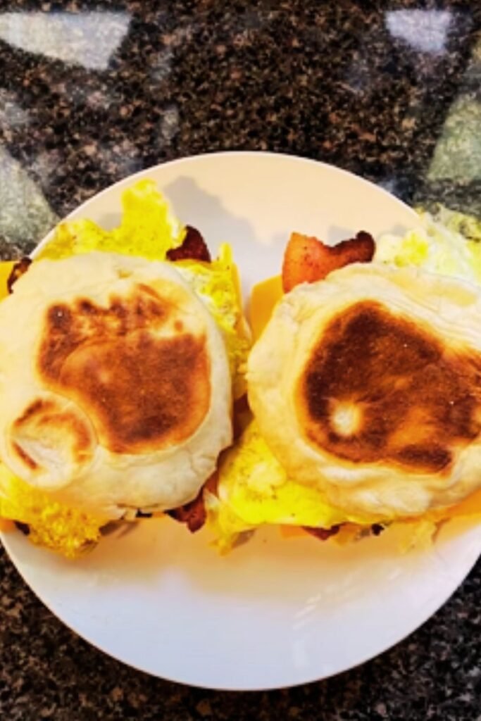 Golden brown English muffins on the griddle